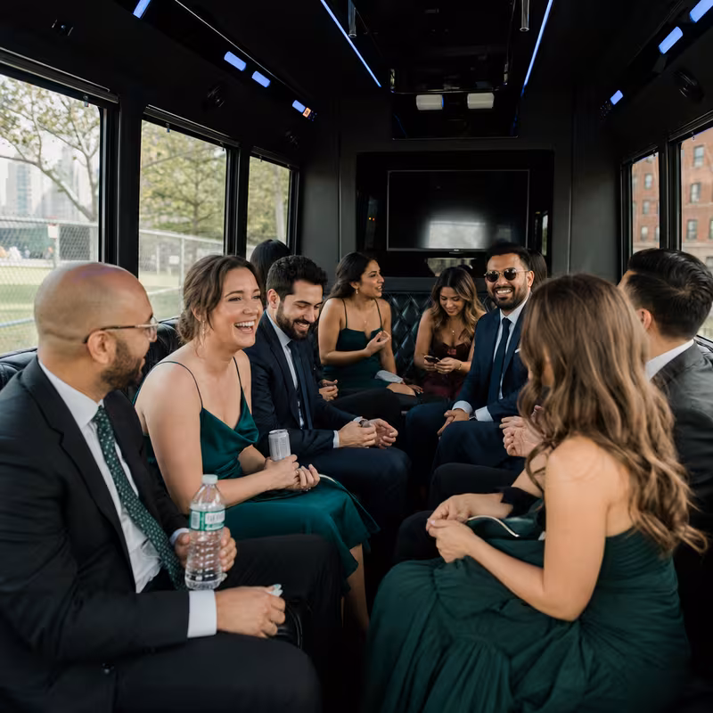 Wedding guests seated inside a Brooklyn party bus